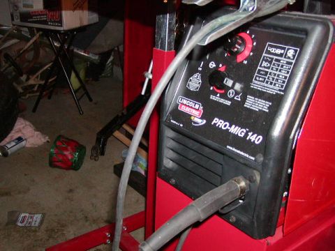 1978 Ford Bronco - Close-up of a Lincoln Electric Pro-MIG 140 welder, showing control panel and connections.