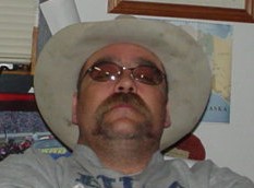 1978 Ford Bronco - Man in cowboy hat and sunglasses with a prominent mustache.