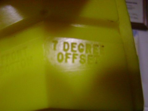 1978 Ford Bronco - Close-up of a yellow plastic component showing embossed lettering that reads '7 DEGREE OFFSET'.