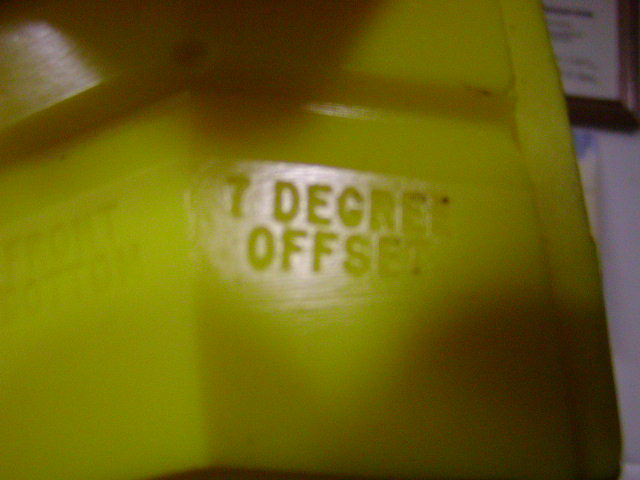 Yellow plastic part with embossed text '7 DEGREE OFFSET'