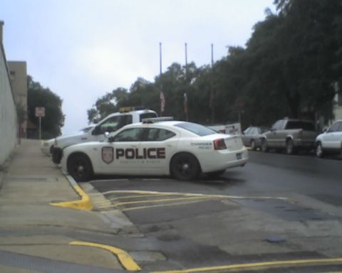2000 Ford Crown Victoria - A police car is parked on the side of the road with other vehicles visible in the background.
