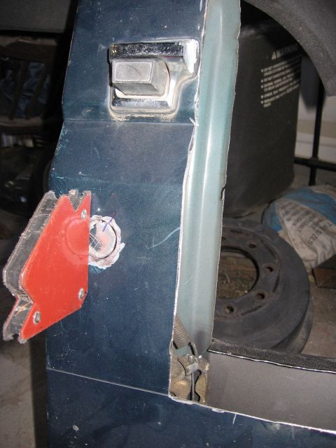 1994 Ford Bronco - Close-up of a vehicle's door latch mechanism, with a red protective cover detached.