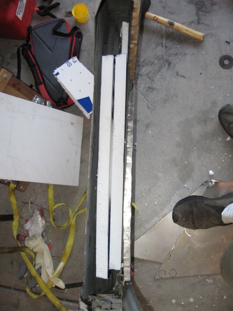1994 Ford Bronco - Work in progress on a vehicle door panel, showing foam insulation and metal supports.
