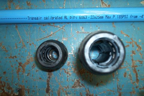 1983 Ford Bronco - Transair pipe and fittings shown on a textured blue surface.