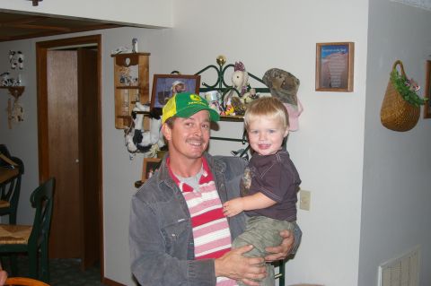 1998 Jeep TJ - A man and a young child pose for a photo inside a home.