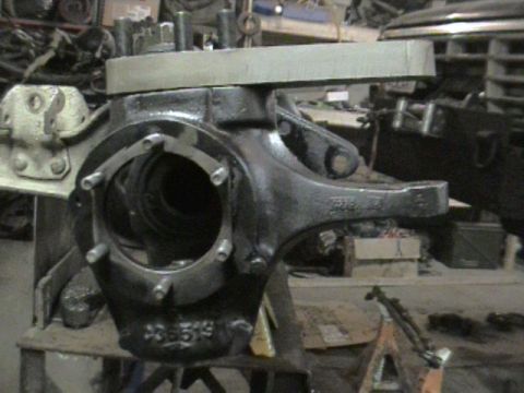 1985 Ford Bronco - A vehicle axle housing, identified by part number C3B519, is shown in a workshop setting.