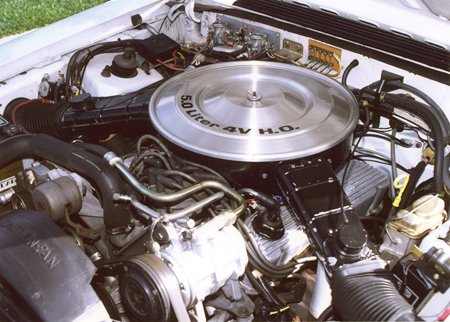 1987 Ford Mustang - The engine bay of a 1987 Ford Mustang is visible, a 5.0 Liter 4V H.O. engine.