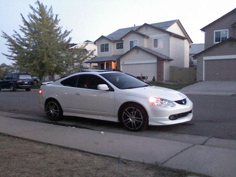 1996 Ford Probe - White Acura RSX parked on a residential street with houses in the background.