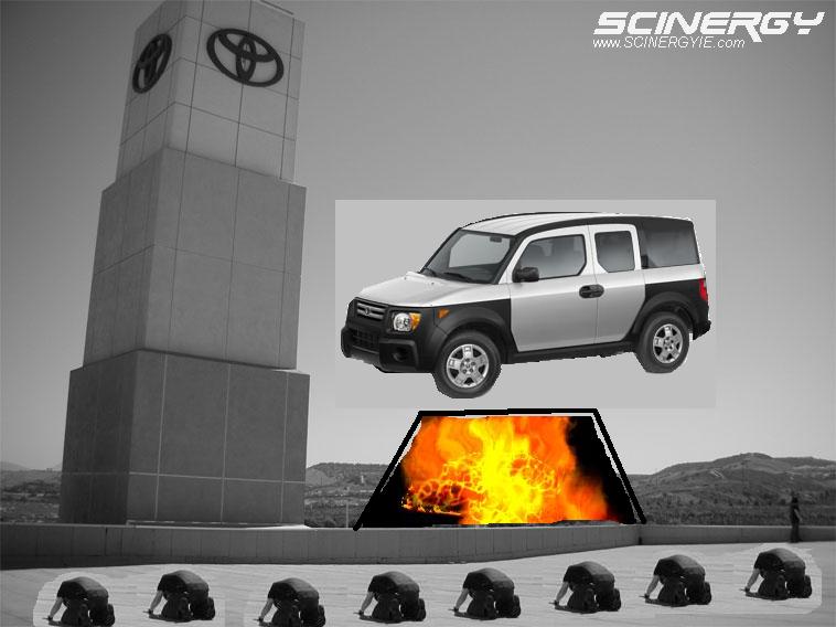 Silver and black SUV parked in front of a Toyota tower with a fire pit below