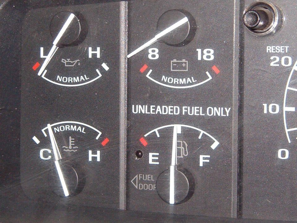Vehicle instrument cluster gauges showing oil, battery, temp and fuel