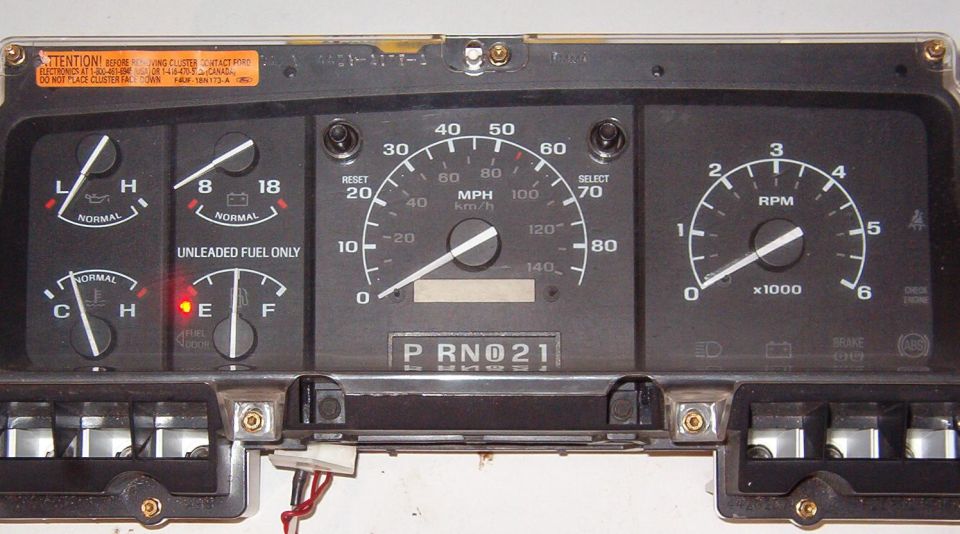 Removed truck instrument cluster with speedometer, tach and gauges