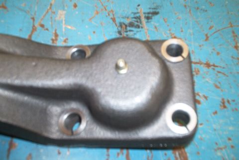 1983 Ford Bronco - Close-up of a metal steering arm component, likely from a vehicle's steering system.