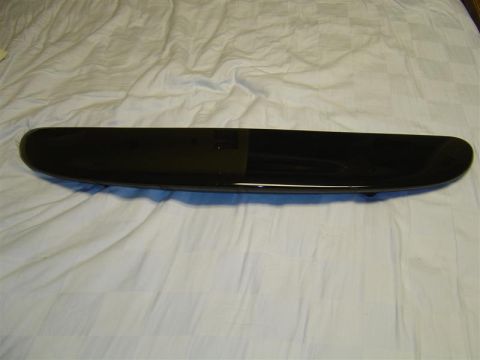 1994 Ford Taurus - This is a black rear spoiler, likely for a car, shown against a white, textured surface.