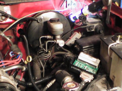 1991 Ford Bronco - This image shows various engine bay components, including the brake master cylinder and electronic control units.