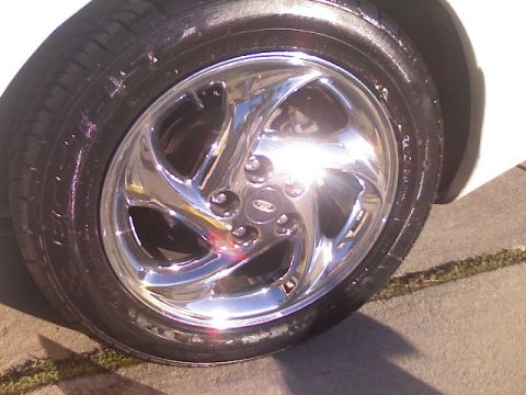 1996 Ford Probe - Close-up of a shiny chrome wheel and tire.