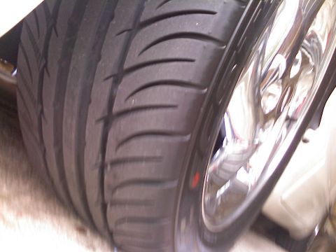 1996 Ford Probe - Detail of a tire and chrome wheel, likely from a custom car build.