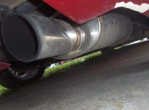 1995 Ford Probe - Close-up view of a vehicle's exhaust system, showing a large, shiny muffler and pipe.