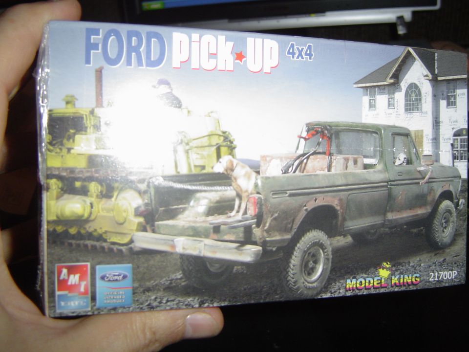Hand holding an AMT Model King Ford Pick-Up 4x4 plastic model kit box