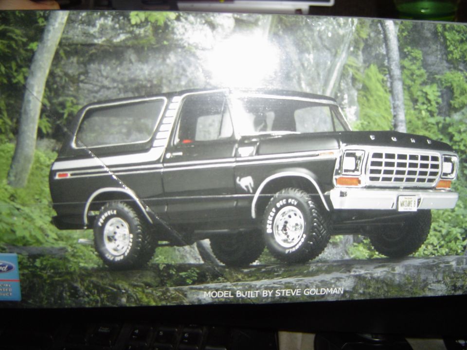 Monitor showing a black late-1970s Ford Bronco scale model posed in a forest diorama