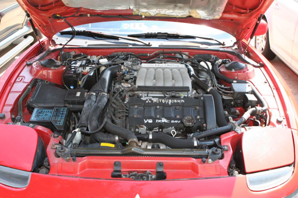 Mitsubishi V6 DOHC 24V engine bay of red sports car