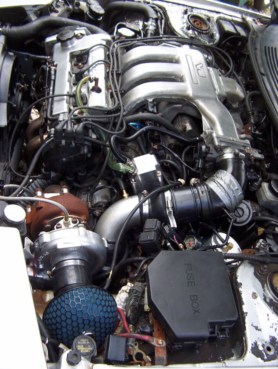 Engine bay with turbo manifold and blue cone air filter