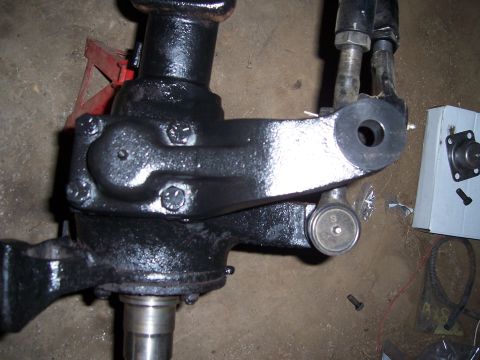 1983 Ford Bronco - Close-up view of a vehicle's steering arm component, showing its mechanical details and a grease fitting.