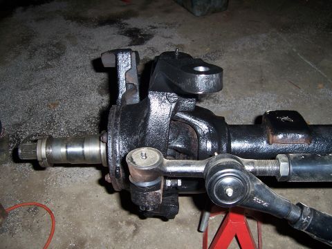 1983 Ford Bronco - This steering linkage assembly is mounted on a red jack stand, ready for installation or repair.