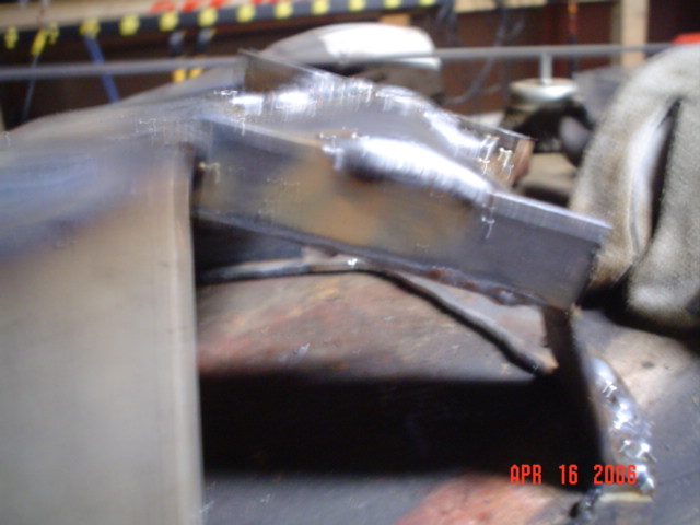 I ran an angled piece as a gusset of sorts across the bend, filled with metal to metal, and capped sides. This is for added protection at the impact area.