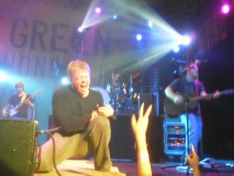 1989 Ford Bronco - A band plays live on stage under bright lights, with a banner visible in the background.
