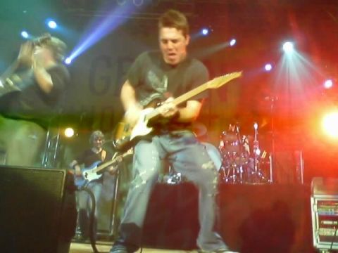 1989 Ford Bronco - A band performs live on stage with bright lights and musical instruments.