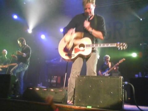 1989 Ford Bronco - Musicians perform live on stage with guitars and microphones.
