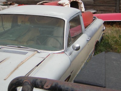 1972 Ford Ranchero - This early 1960s Ford Ranchero is in a state of disrepair, with visible rust and a faded paint job.