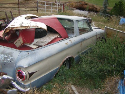 1972 Ford Ranchero - This pickup truck, likely from the early 1960s, is filled with various parts and a spare tire in its bed.