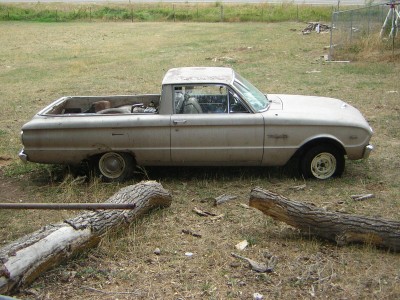 1972 Ford Ranchero - This vintage Ford Falcon Ranchero pickup truck is seen from the side in a dry, grassy area with fallen logs.