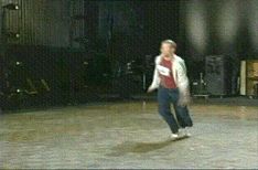 1999 Chrysler 300M - A person is captured mid-air during a jump in an outdoor setting at night.