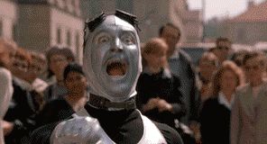 1999 Chrysler 300M - A man with painted face is seen screaming in a crowd of people.