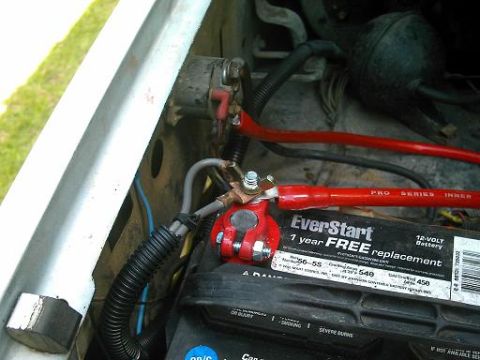 1986 Ford Bronco - Close-up view of a vehicle's engine bay, focusing on the battery and associated components.