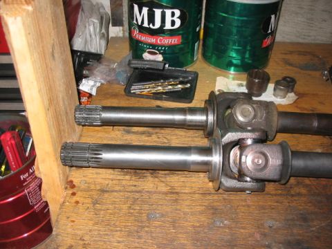 1995 Ford Bronco - Close-up of Yukon Alloy U-joints and shafts, likely automotive parts.