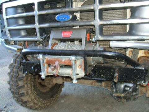 1995 Ford Bronco - This Ford Bronco features a prominent WARN winch and aftermarket bumper, with its grille indicating an earlier model year than claimed.