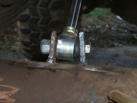 1995 Ford Bronco - This photo shows a close-up view of a vehicle's suspension system, focusing on a welded bracket and bolts.