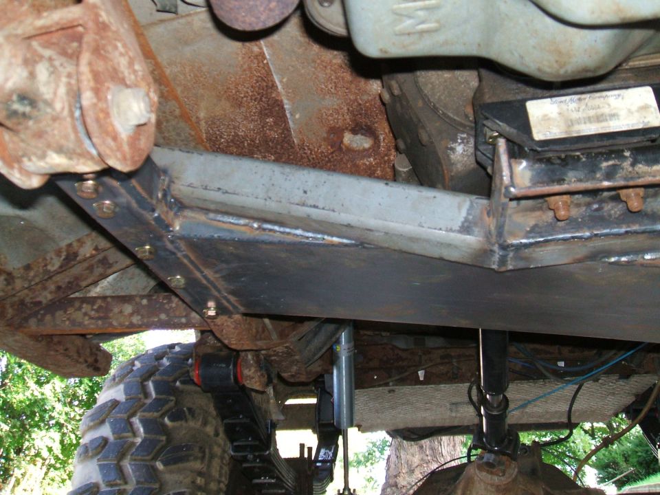 Underbody view of a vehicle with a custom skid plate and suspension modifications