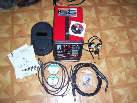 1983 Ford Bronco - A Lincoln 175HD welder is shown with its accompanying mask, wire spools, hoses, and instruction manuals.