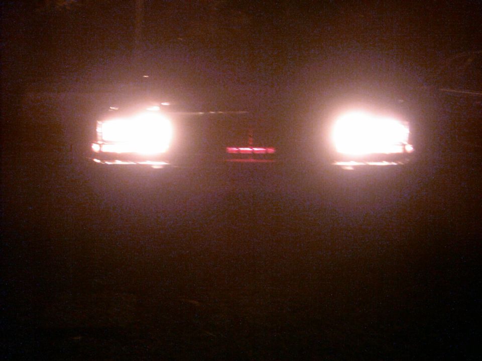 1985 Ford Crown Victoria LTD front grille and headlights illuminated at night