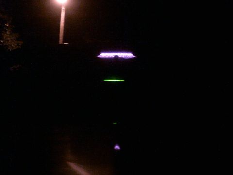 1985 Ford Crown Victoria LTD - The interior of a vehicle is illuminated by purple and green lights at night.