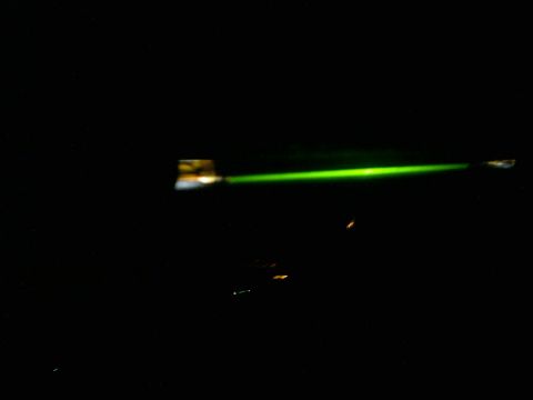 1985 Ford Crown Victoria LTD - A bright green laser beam cuts through the darkness, with a website logo visible.