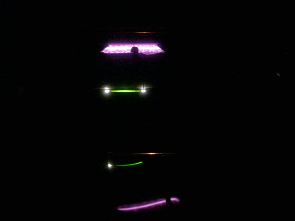Car lights at night, with purple and green illumination