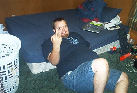 1985 Ford Crown Victoria LTD - Man in a bedroom gives the middle finger while lying on a bed.