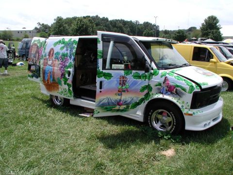 1978 Ford Mustang II - This van features a detailed mural with grapes, a woman, and a mountain landscape.