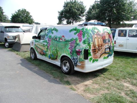 1978 Ford Mustang II - A van is decorated with a mural depicting a vineyard, grapes, and wine barrels.