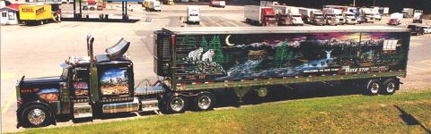 1978 Ford Mustang II - A custom-painted semi-trailer truck is parked at a truck stop with other vehicles visible.